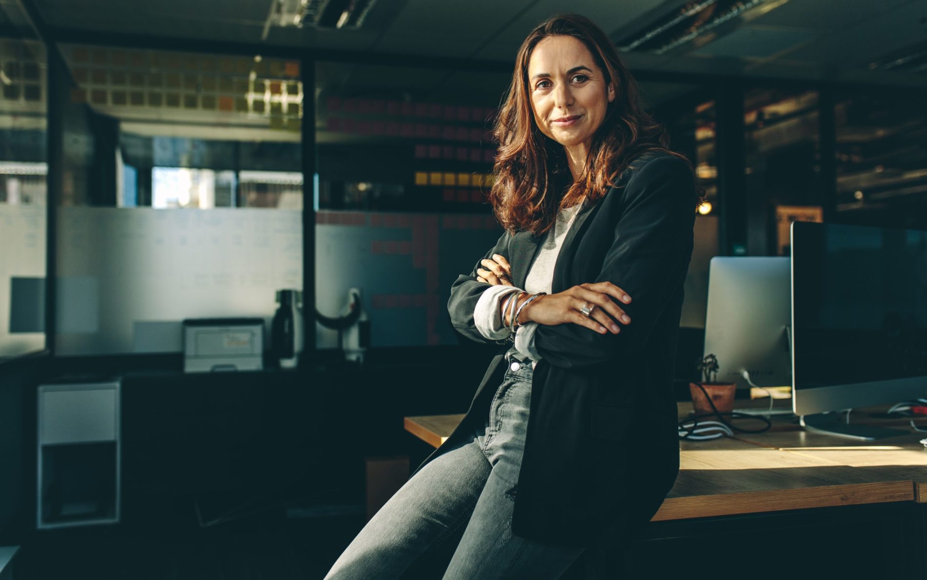 Mature businesswoman sitting on her desk.